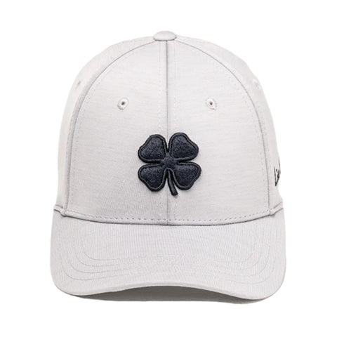 A light gray cap features a black embroidered four-leaf clover at the front The cap is designed for casual wear and is suitable for outdoor activities