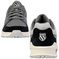 A pair of athletic shoes features a mix of grey mesh and black suede. They sit upright showing laces and branding, set against a plain white background.