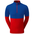 A long-sleeved athletic shirt features a blue upper section with a zippered collar and a red lower section. It is designed for active wear, providing comfort and style.