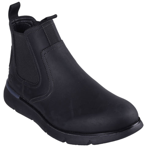 A black ankle boot featuring a smooth surface elastic side panels and a slight heel is positioned upright against a neutral background showcasing its sleek design suitable for casual or formal wear.