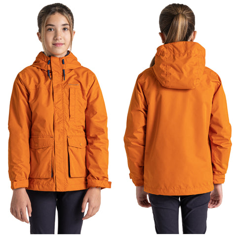 A child wearing an orange jacket stands facing forward and backward showcasing the jacket's design which features a hood and front pockets in a neutral background.