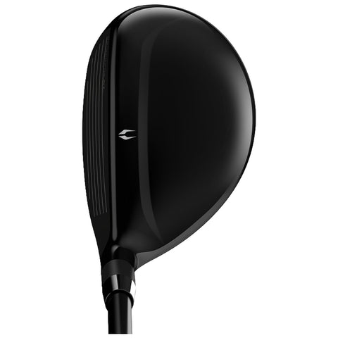 A glossy black golf club head sits upright showcasing its smooth surface and detailed grooved face designed for striking a golf ball in an outdoor sporting environment.