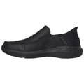 A sleek black slip-on shoe features a smooth surface and textured back, designed for comfort and casual wear, perfect for versatile settings and easy on-off use.