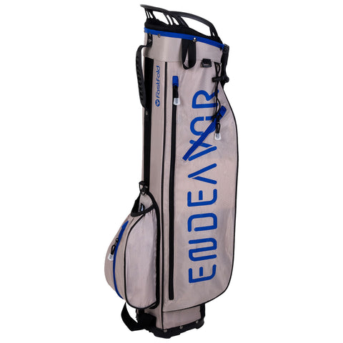 A golf bag stands upright with a sleek design featuring a light gray color and blue lettering The bag includes multiple compartments for storage and has a handle for easy transport