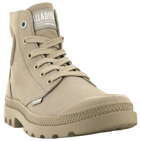 A beige high-top shoe with laces and a slightly textured sole is positioned forward against a neutral background showcasing its design and details. The label indicates the brand Palladium.