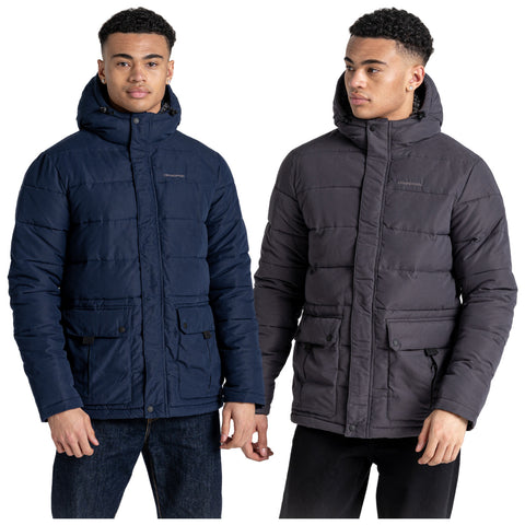 Two young men stand side by side each wearing a puffy winter jacket in different colors one in navy blue and the other in dark gray both jackets have hoods and front pockets.