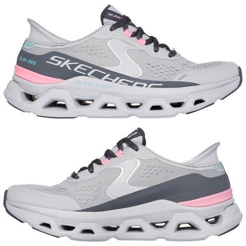 A pair of gray athletic shoes features a sleek design with pink and blue accents showcasing a cushioned sole. The shoes are positioned side by side emphasizing their sporty style.