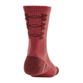 A red athletic sock is standing upright showcasing its ribbed texture and pattern details on the side while the heel is positioned facing the viewer in a neutral setting.