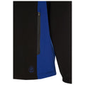 A two-tone jacket features a black exterior with a blue panel on the side and a zippered pocket, designed for functionality and style in an outdoor context.