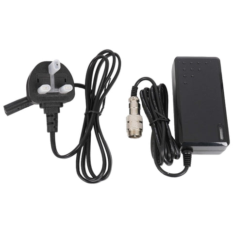 A power adapter with a three-prong plug is connected to a rectangular black box and wires leading to a connector, suitable for delivering electrical power in a hardware setup.