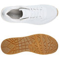 A white athletic shoe featuring a breathable upper and memory foam insole is positioned above a textured rubber outsole with a patterned grip, showcasing its design for comfort and traction.