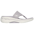 A light purple slide sandal is displayed sideways resting on a flat surface featuring a textured strap and a cushioned sole ideal for casual wear and comfort.