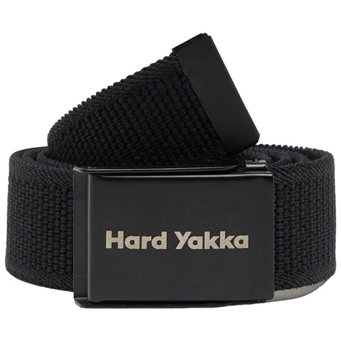 A black fabric belt with a shiny metal buckle displaying the text "Hard Yakka" is coiled on a flat surface, ready for use in securing clothing.