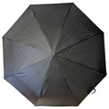 A black umbrella is open and displayed from above showing a smooth fabric surface with eight sections arranged symmetrically the context is neutral with no people or environmental elements visible.