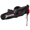 A black and red golf bag with the brand name Srixon displayed prominently is leaning against a support leg in a neutral setting designed for carrying and organizing golf clubs and accessories.