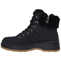 A black ankle boot with a fur-lined cuff features laces and a side zipper while resting on a white background highlighting its rugged sole and stylish design.