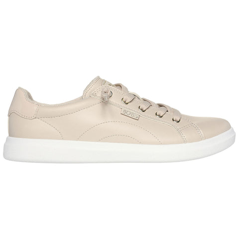 Beige leather sneaker with a white rubber sole is positioned horizontally showing laces and rounded toe against a plain white background