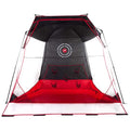 A large tent featuring a black and red color scheme with mesh panels is set up for activity The tent has targets marked inside and appears suitable for games or sport practice