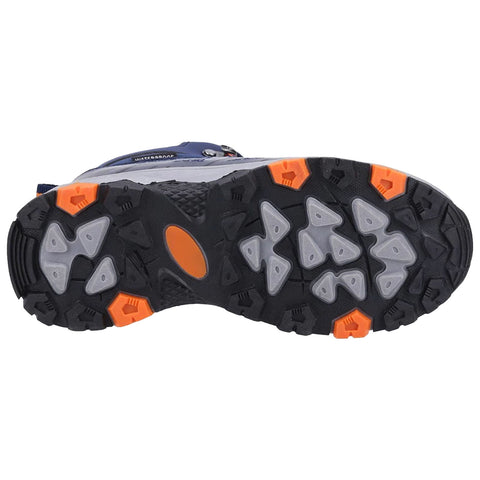 A shoe sole featuring large rubber lugs for traction sits on a flat surface showcasing a primarily black and gray design with orange accents highlighting key sections for grip and durability.