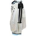 A white golf bag stands upright featuring multiple zippered pockets for storage and a structured top to hold clubs securely in place designed for outdoor golfing activities.