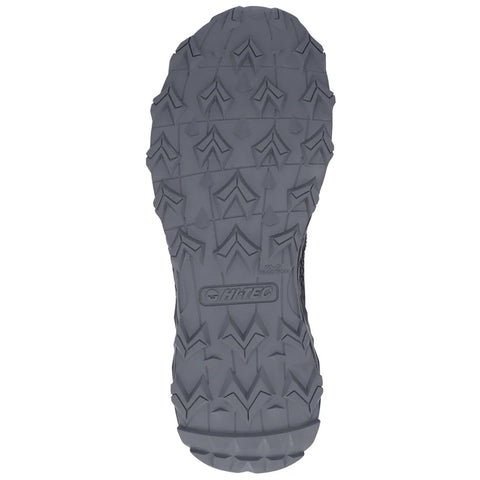 A rugged shoe sole with deep treads is positioned downward showcasing its grip design ideal for traction on uneven surfaces in outdoor environments.