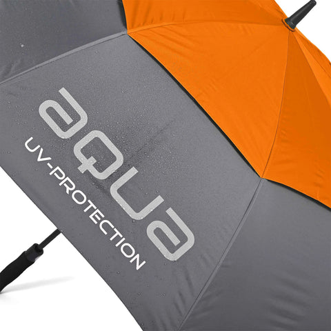 A partially opened umbrella features an orange top and gray bottom with water droplets visible on its surface showcasing its UV protection label against a likely outdoor setting.