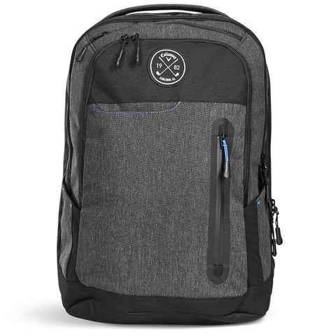 A black and grey backpack stands upright featuring multiple zippered compartments and a circular logo on the front with the numbers 1982 suggesting a modern yet classic design suitable for daily use.