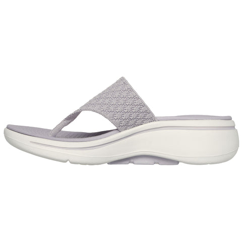 A light gray sandal is displayed from the side featuring a textured strap and a white cushioned sole designed for comfort and casual wear suitable for warm weather environments.