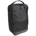 A black backpack with a textured surface sits upright featuring a top handle and a branded logo at the bottom, designed for carrying personal items comfortably.