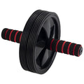 A black and red abdominal roller features a large wheel with deep grooves and two padded handles on each side used for core strengthening exercises typically performed on a flat surface.