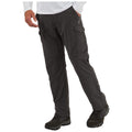 Outdoor cargo pants are being worn by a person standing with one hand on the hip and the other hand slightly raised in an active stance the environment appears to be plain and neutral