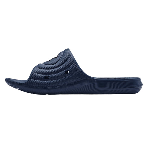 A dark blue slip-on sandal sits horizontally showcasing its textured surface and curved design highlighting ventilation holes and a flexible sole suggesting comfort and casual wear in a relaxed setting.