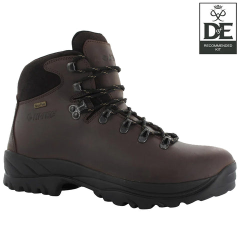 A brown hiking boot stands upright featuring metal eyelets and thick laces designed for secure fastening showcasing a rugged sole suitable for outdoor terrain and waterproofing technology