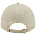 A beige mesh cap is positioned upright showcasing its textured surface and adjustable strap at the back in a neutral setting with no distractions or additional objects present.