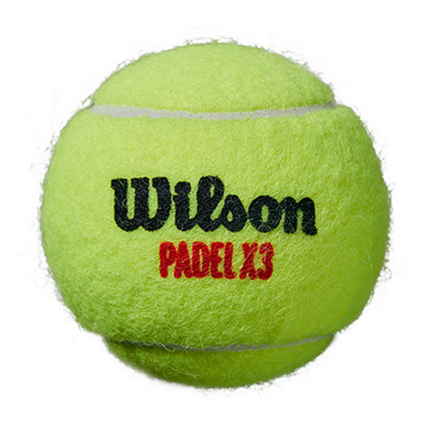 A bright green padel ball sits stationary showcasing fuzzy texture with "Wilson" written in black and "PADEL X3" in red on its surface against a plain background.