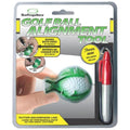 A green golf ball alignment tool is being held by a hand while a red Sharpie is included in a package that explains how to mark both sides of the ball