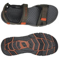 A pair of sandals rests on a flat surface featuring wide adjustable straps and a textured insole the outsole has a rugged pattern for traction and durability