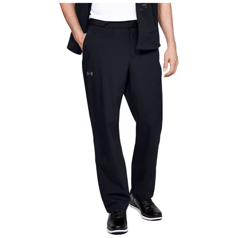 Black GOLF pants are being worn by a person standing upright with hands in pockets. The setting is likely indoors given the neutral background, featuring solid colors.