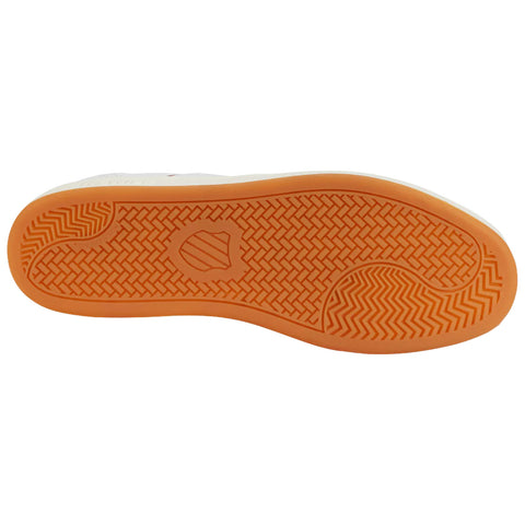 A shoe sole features a patterned rubber texture with an orange color underneath and a logo shape in the center providing traction for various surfaces.