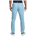 Light blue golf chinos are worn by a person standing upright in a neutral pose within a casual setting. The chinos are styled with a black belt and white sneakers against a simple background.