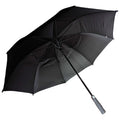 A black umbrella is opened with its canopy fully extended providing shade or protection from rain its long handle featuring a soft grip stands upright against a neutral background.