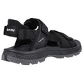 Black hiking sandals are positioned on a flat surface showcasing adjustable straps and a rugged sole designed for outdoor activities providing comfort and support in varying terrains