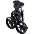 A compact folding golf pushcart is displayed in a stacked position featuring three large black wheels and a frame made of metal with plastic components designed for easy storage and transport.