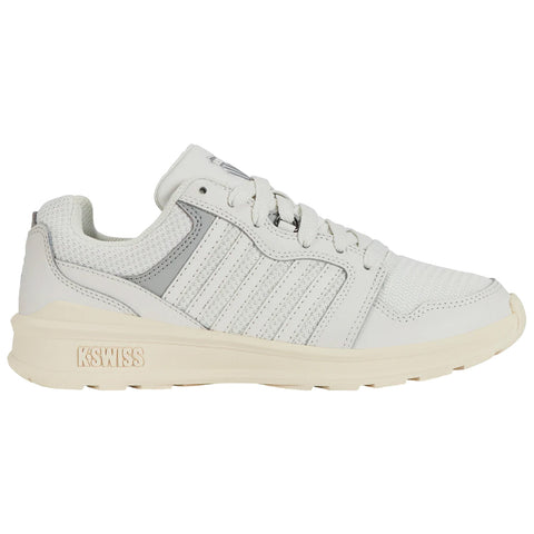 A white sneaker with gray accents displays a textured upper and features several stripes on the side. It is positioned on a plain white background emphasizing its design.