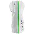 A white golf club headcover stands upright featuring a green stripe and logo detailing a brand name it protects the club head from dirt and damage during storage or transport