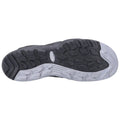 A black and white athletic shoe sole rests flat with clear tread patterns and traction lugs suggesting active use likely in a fitness or outdoor setting.