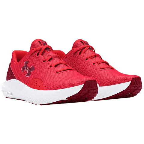 Red athletic shoes are displayed side by side highlighting their textured fabric and contrasting white soles in a plain background suitable for showcasing the footwear.