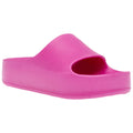 A bright pink slide sandal rests on a plain background showcasing an open toe design and a thick sole typically used for casual wear or indoor comfort.