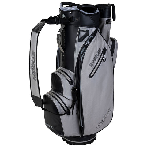 A gray golf bag stands upright featuring multiple zippered pockets and adjustable straps for carrying designed to hold golf clubs and equipment in a sturdy and organized manner.