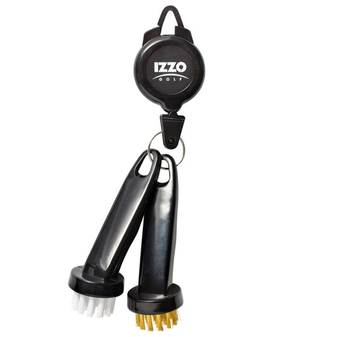 A retractable golf brush tool is attached to a keyring with two brushes one with white bristles and one with brass bristles used for cleaning golf clubs in a golfing context.